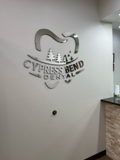 Cypress Bend Dental office photo with a logo on the wall